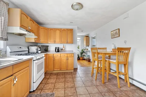 a kitchen with cabinets and chairs