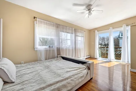 a bedroom with a large bed and a window