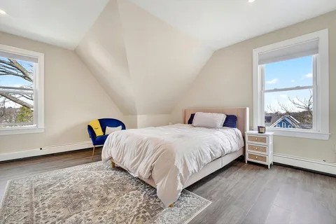 a bedroom with a bed and window