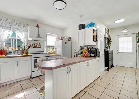 a kitchen with cabinets and window
