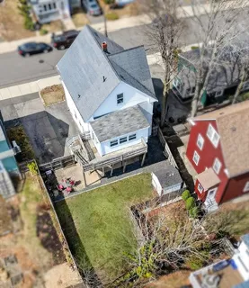 an aerial view of a house with a yard