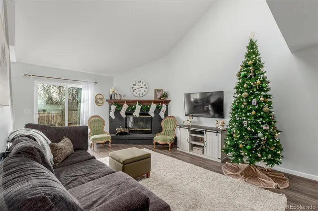 a living room with furniture and a christmas tree