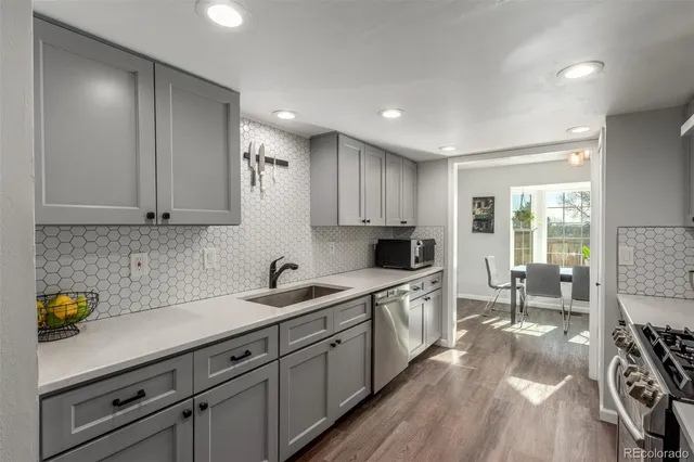 a kitchen with a sink stove and cabinets