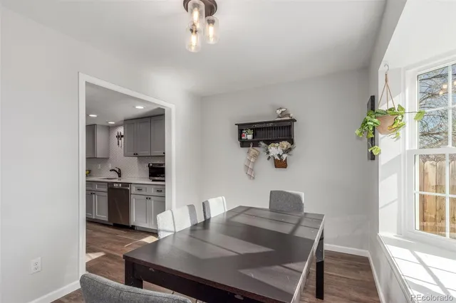 a view of a dining room with furniture and a window