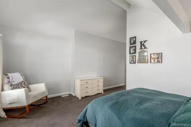 a bedroom with a bed and a couch