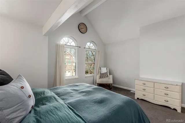 a spacious bedroom with a bed and a window