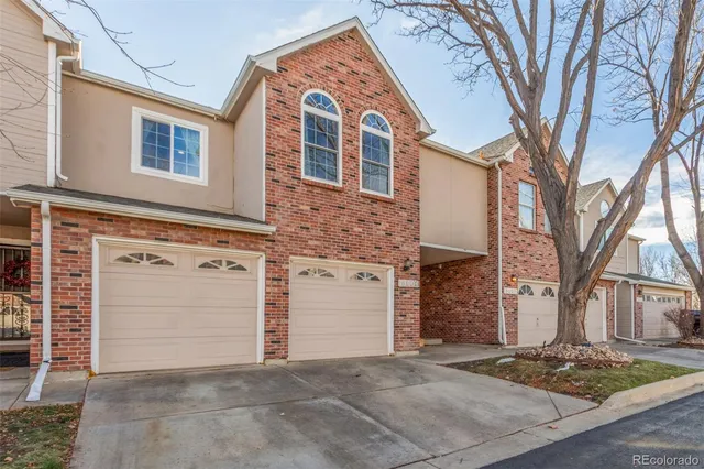 a view of a brick house with large windows