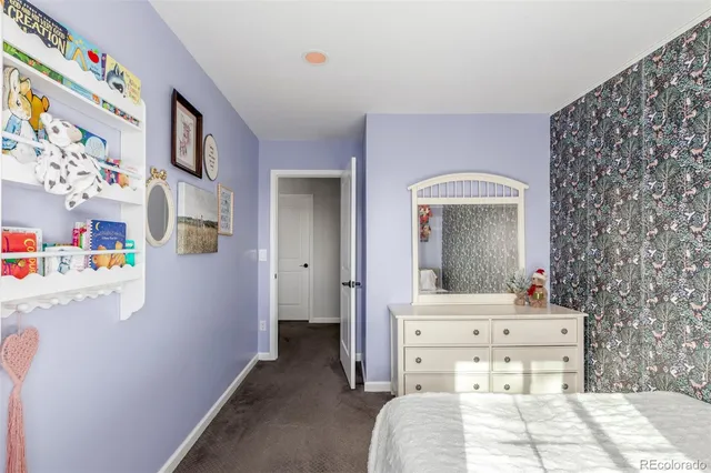 a bedroom with a bed and a mirror