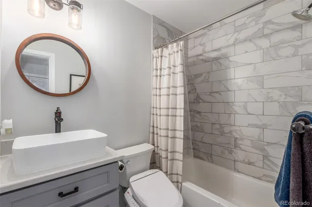 a bathroom with a sink a toilet and a bathtub