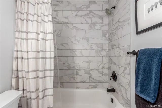 a bathroom with a bathtub and shower