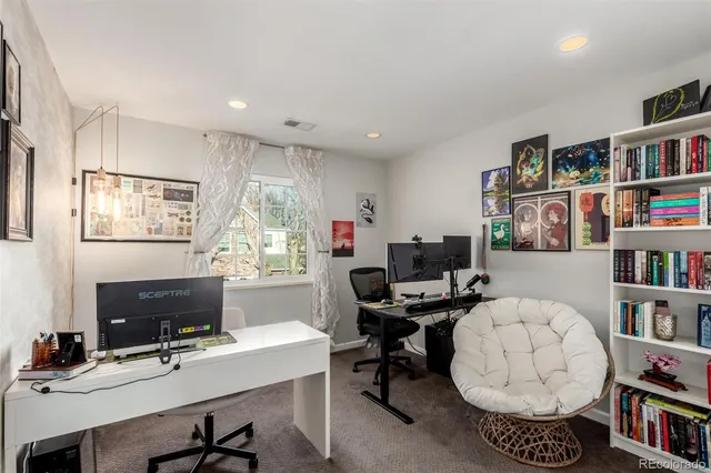 a view of a workspace with furniture and a bookshelf