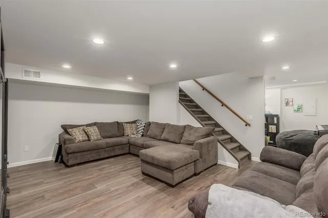 a living room with furniture and stairs