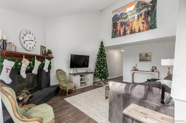 a living room with furniture a flat screen tv and kitchen view