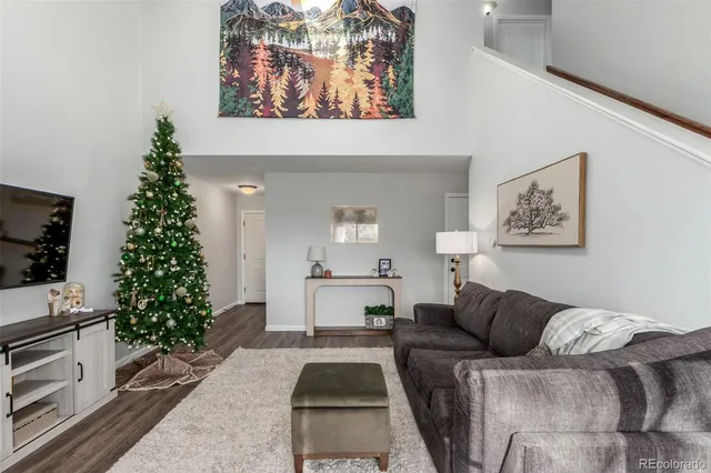 a living room with furniture plant and a window