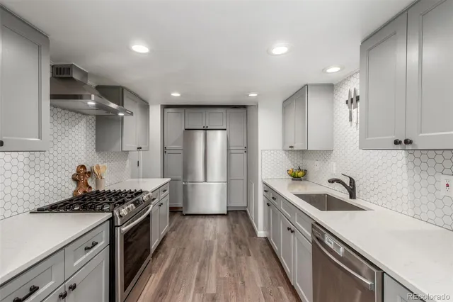 a kitchen with stainless steel appliances a sink stove and refrigerator