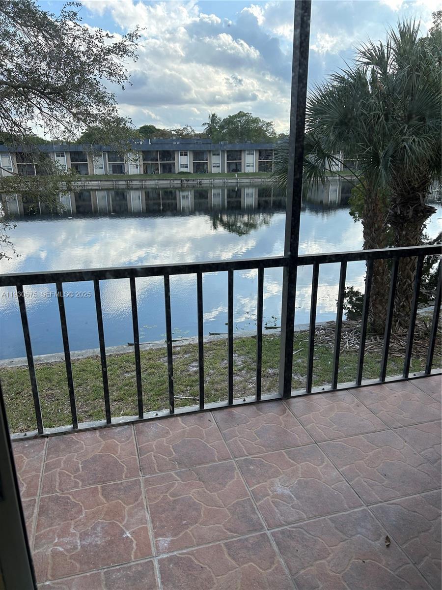 7910 North Colony Circle, Unit 209 Tamarac, FL 33321 - Photo 11 of 19 a balcony with a yard