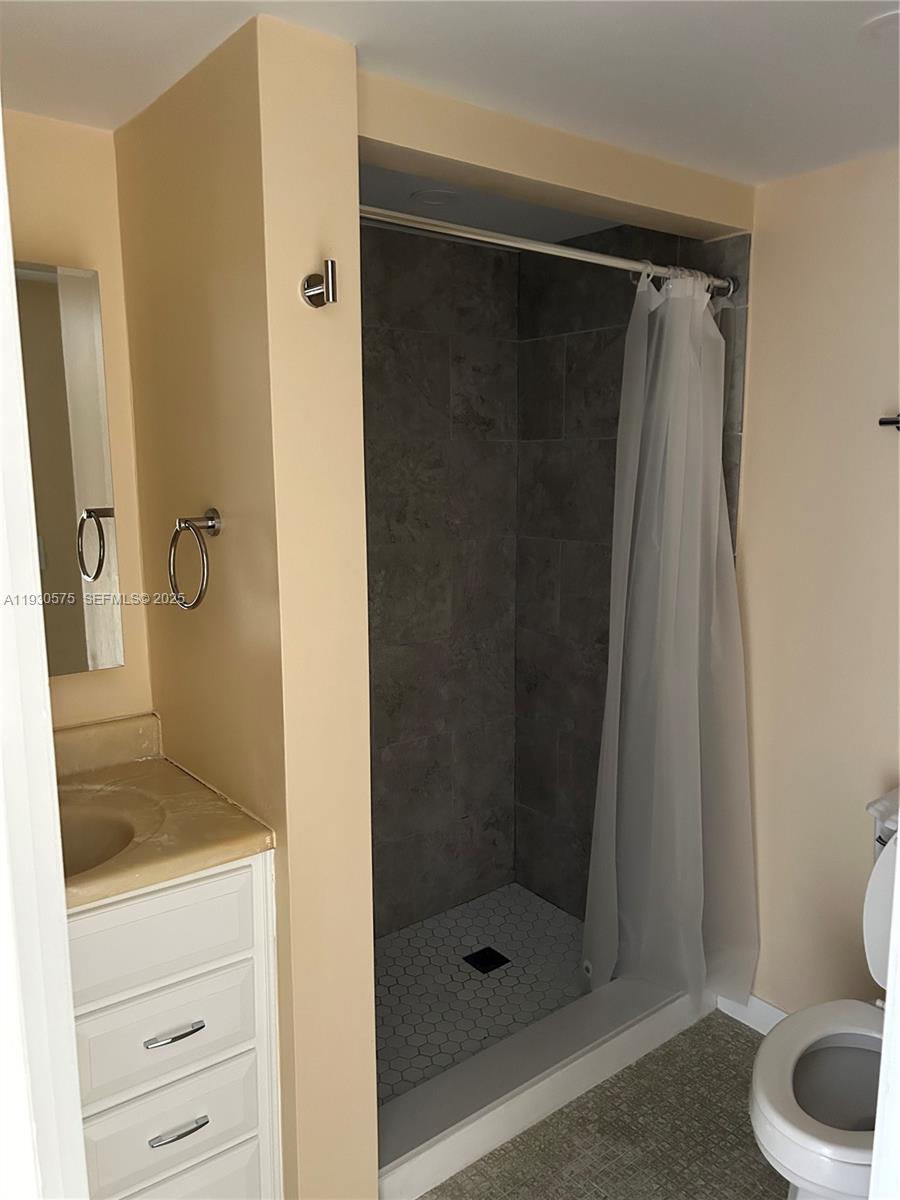 7910 North Colony Circle, Unit 209 Tamarac, FL 33321 - Photo 13 of 19 a bathroom with a shower and a toilet