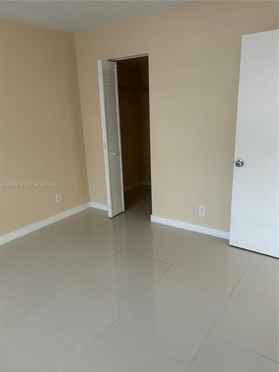 7910 North Colony Circle, Unit 209 Tamarac, FL 33321 - Photo 15 of 19 an empty room with closet
