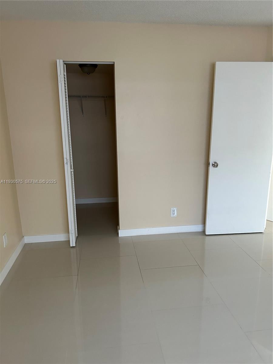 7910 North Colony Circle, Unit 209 Tamarac, FL 33321 - Photo 16 of 19 an empty room with closet