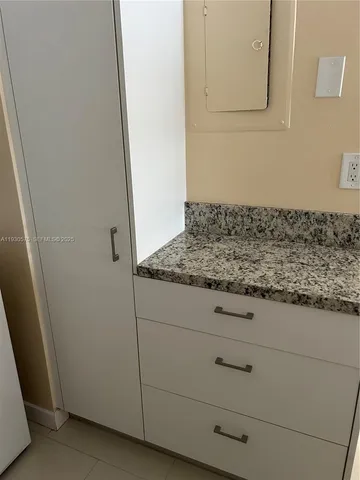 a kitchen with a refrigerator and a stove