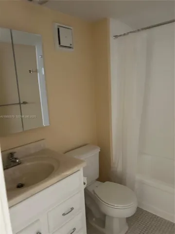 a white toilet sitting next to a bath tub
