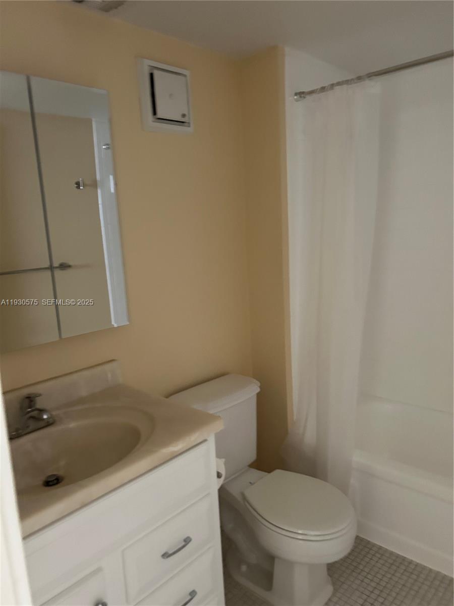 7910 North Colony Circle, Unit 209 Tamarac, FL 33321 - Photo 9 of 19 a white toilet sitting next to a bath tub