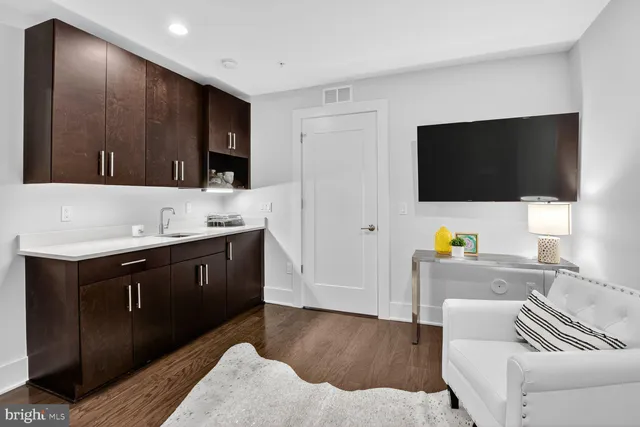 a bedroom with a bed a table and chair