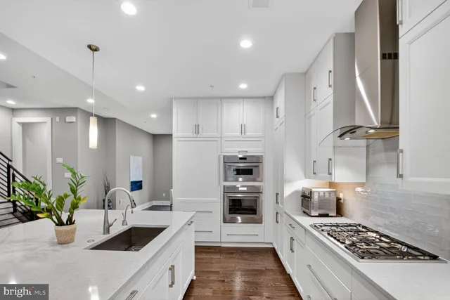 a living room with furniture kitchen and a table
