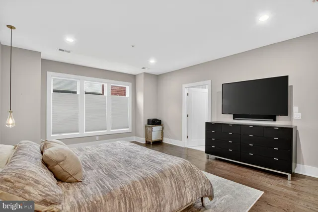 a bedroom with a bed and a tv on table