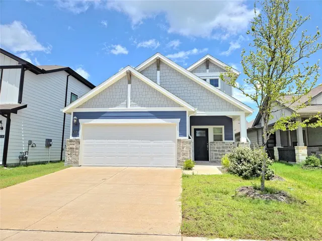 a front view of house with yard and trees around
