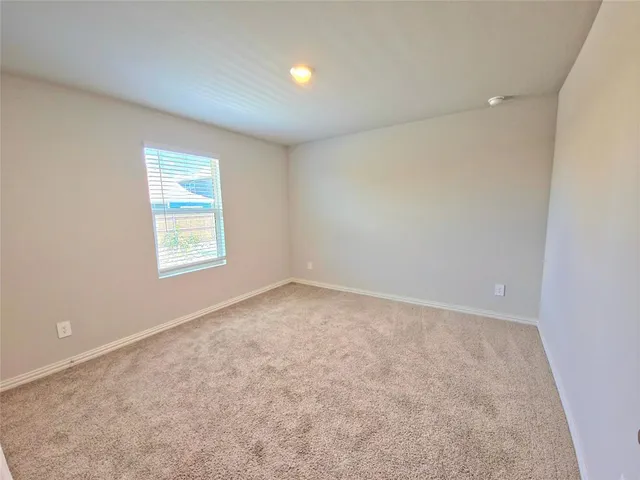 an empty room with a empty space and a window