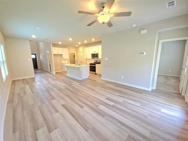 a view of a kitchen and dinning room with wooden floor