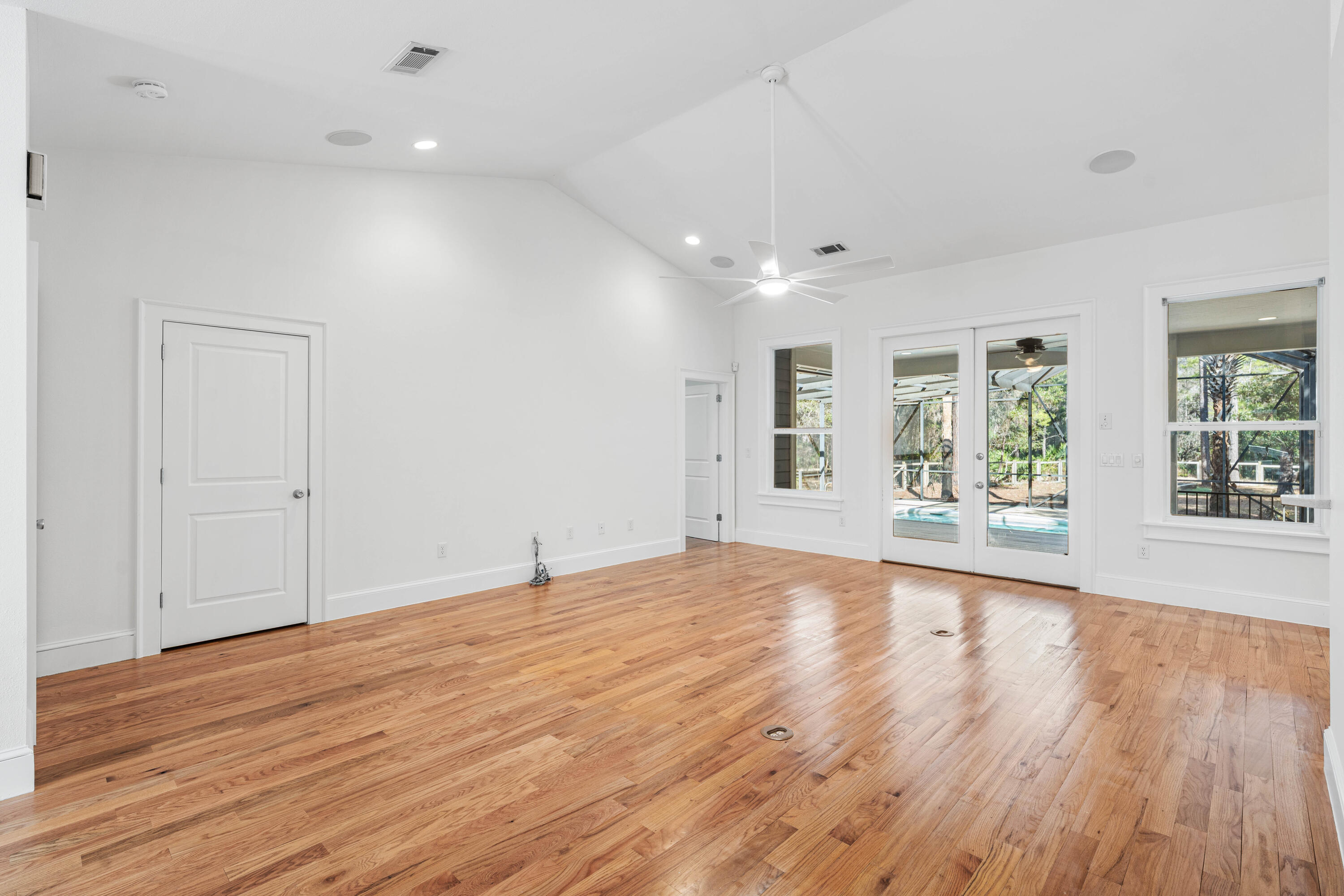 611 Amelia Lane Santa Rosa Beach, FL 32459 - Photo 12 of 59 an empty room with wooden floor and windows