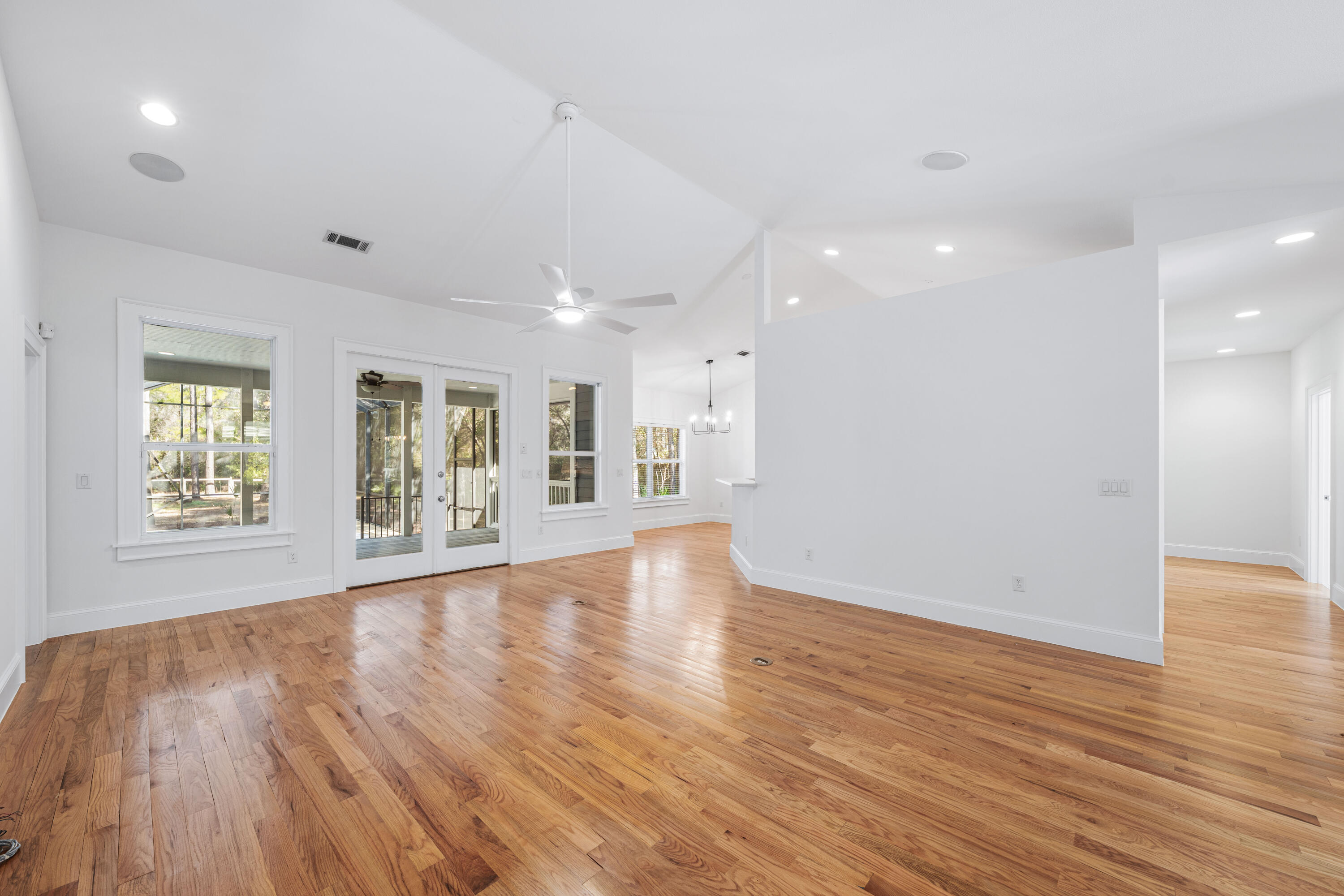 611 Amelia Lane Santa Rosa Beach, FL 32459 - Photo 14 of 59 a view of an empty room with wooden floor and a window