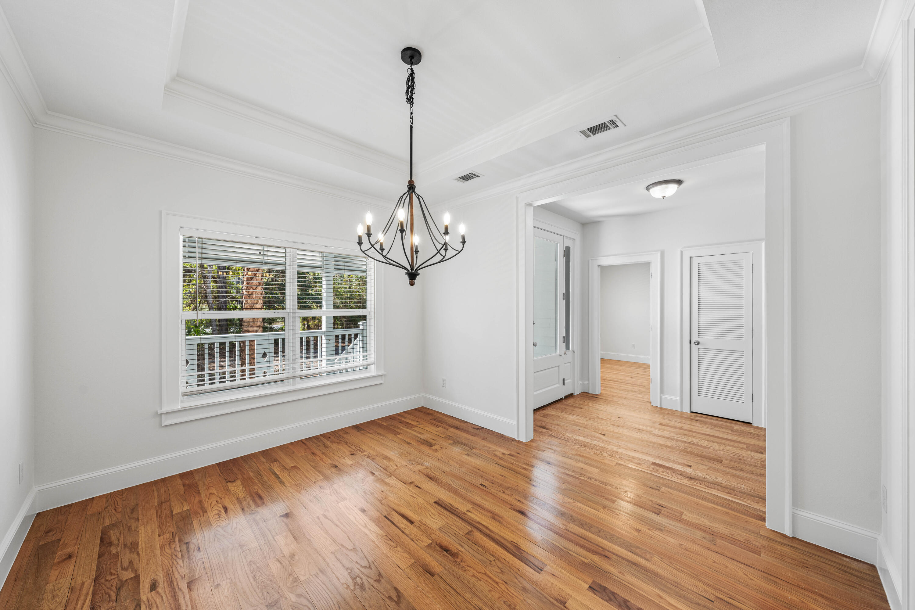 611 Amelia Lane Santa Rosa Beach, FL 32459 - Photo 15 of 59 a view of empty room with wooden floor and fan