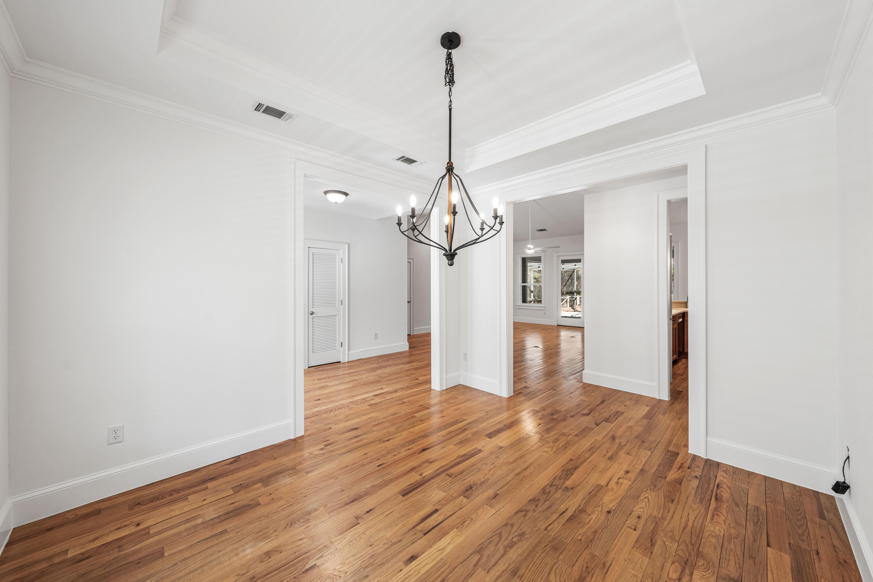 611 Amelia Lane Santa Rosa Beach, FL 32459 - Photo 16 of 59 a view of a room with wooden floor kitchen and a window