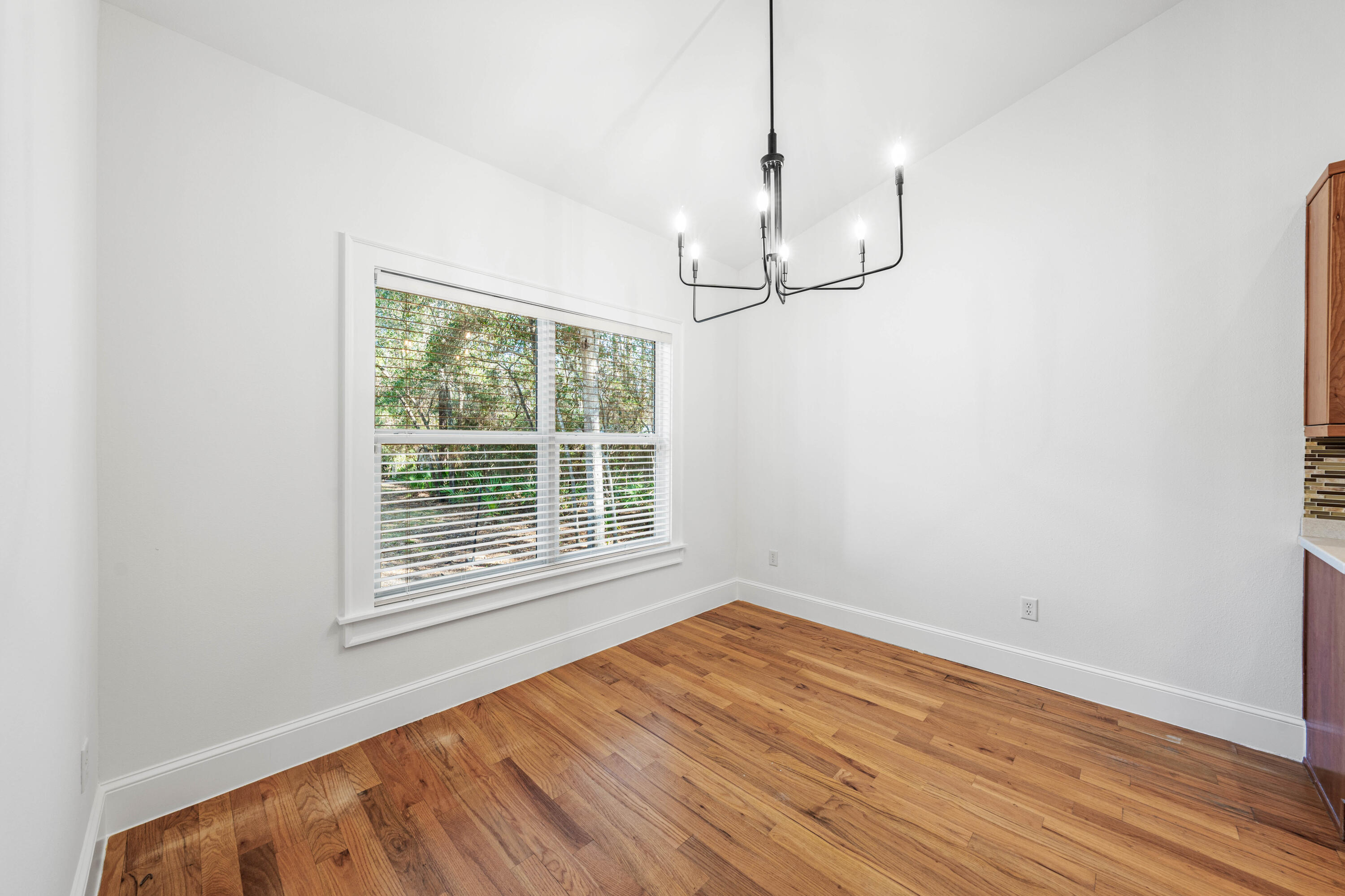 611 Amelia Lane Santa Rosa Beach, FL 32459 - Photo 17 of 59 a view of empty room with wooden floor and fan