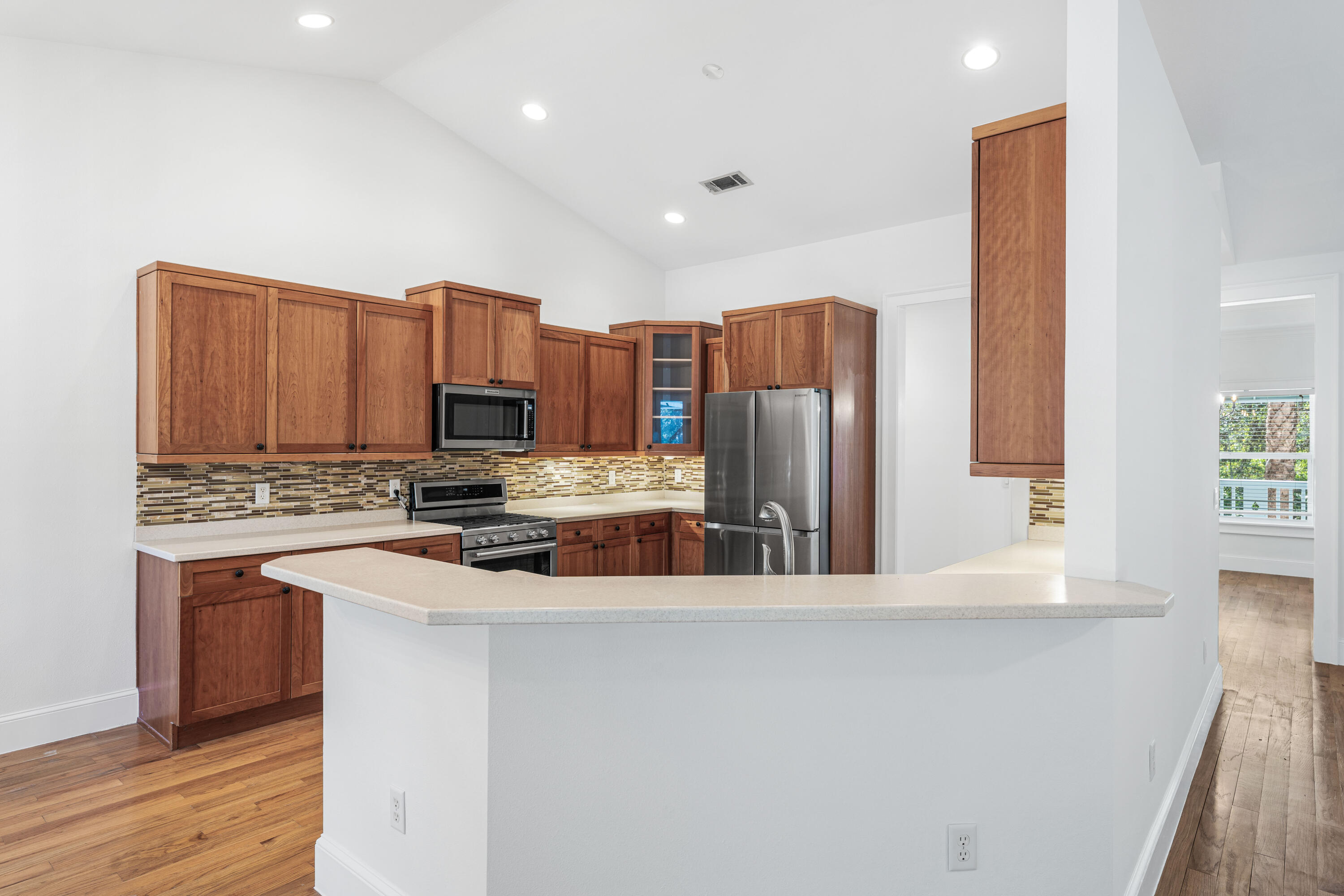 611 Amelia Lane Santa Rosa Beach, FL 32459 - Photo 18 of 59 a kitchen with stainless steel appliances a refrigerator and a stove top oven
