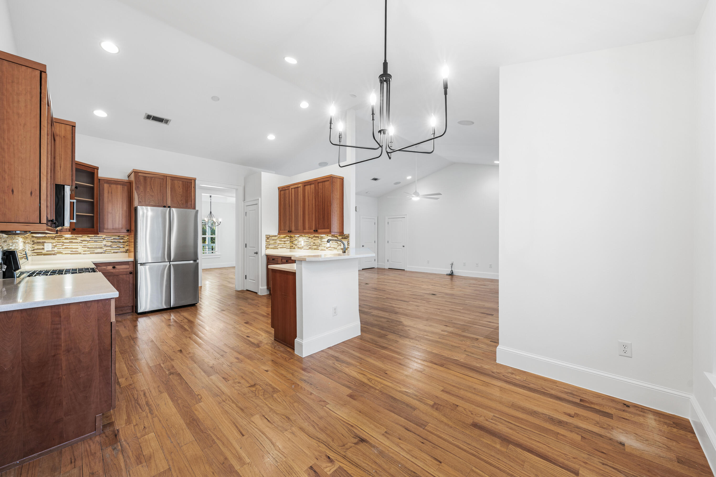 611 Amelia Lane Santa Rosa Beach, FL 32459 - Photo 19 of 59 a open kitchen with a refrigerator and wooden floor