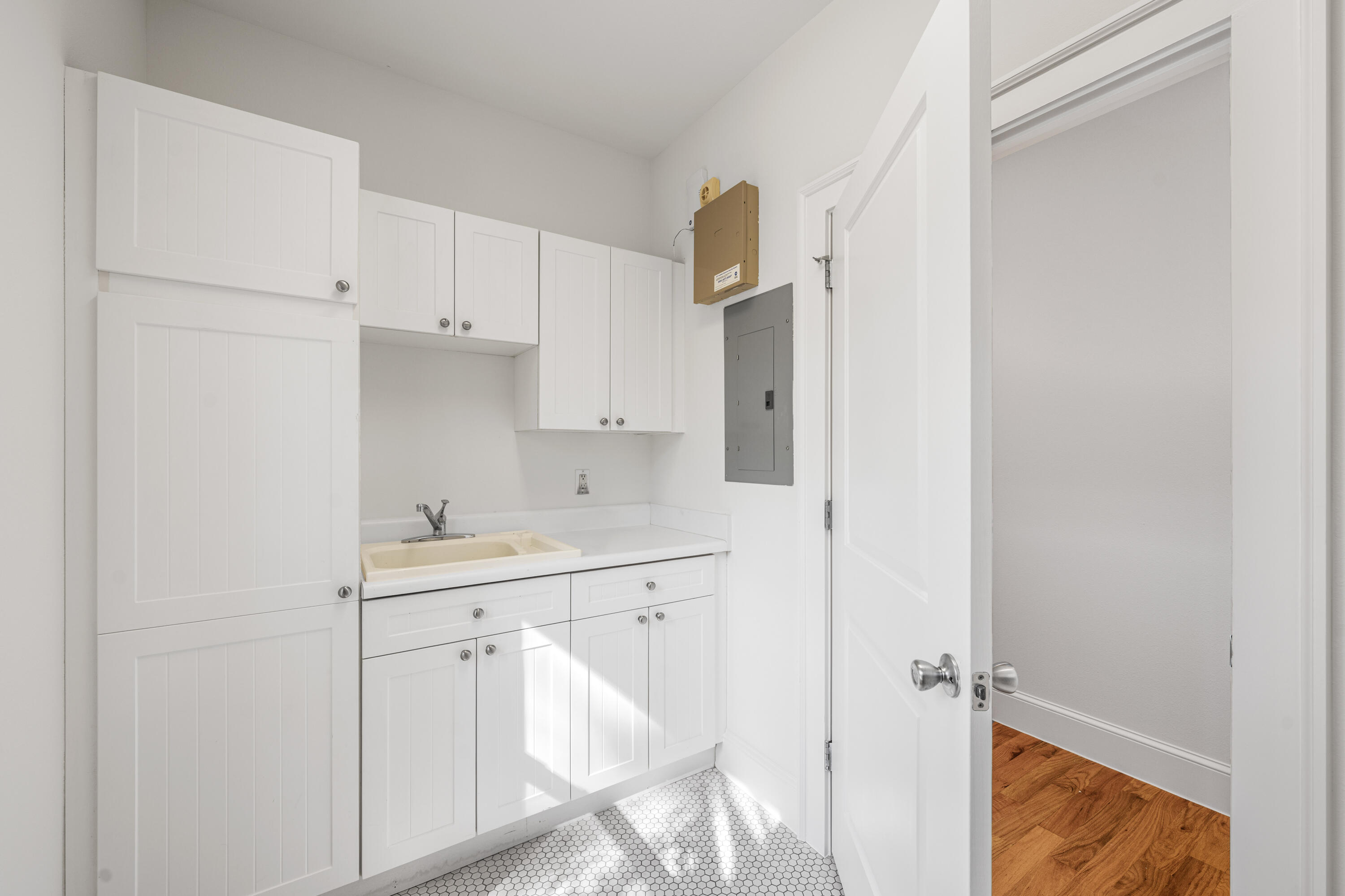 611 Amelia Lane Santa Rosa Beach, FL 32459 - Photo 26 of 59 a view of a kitchen with white cabinets and wooden floor