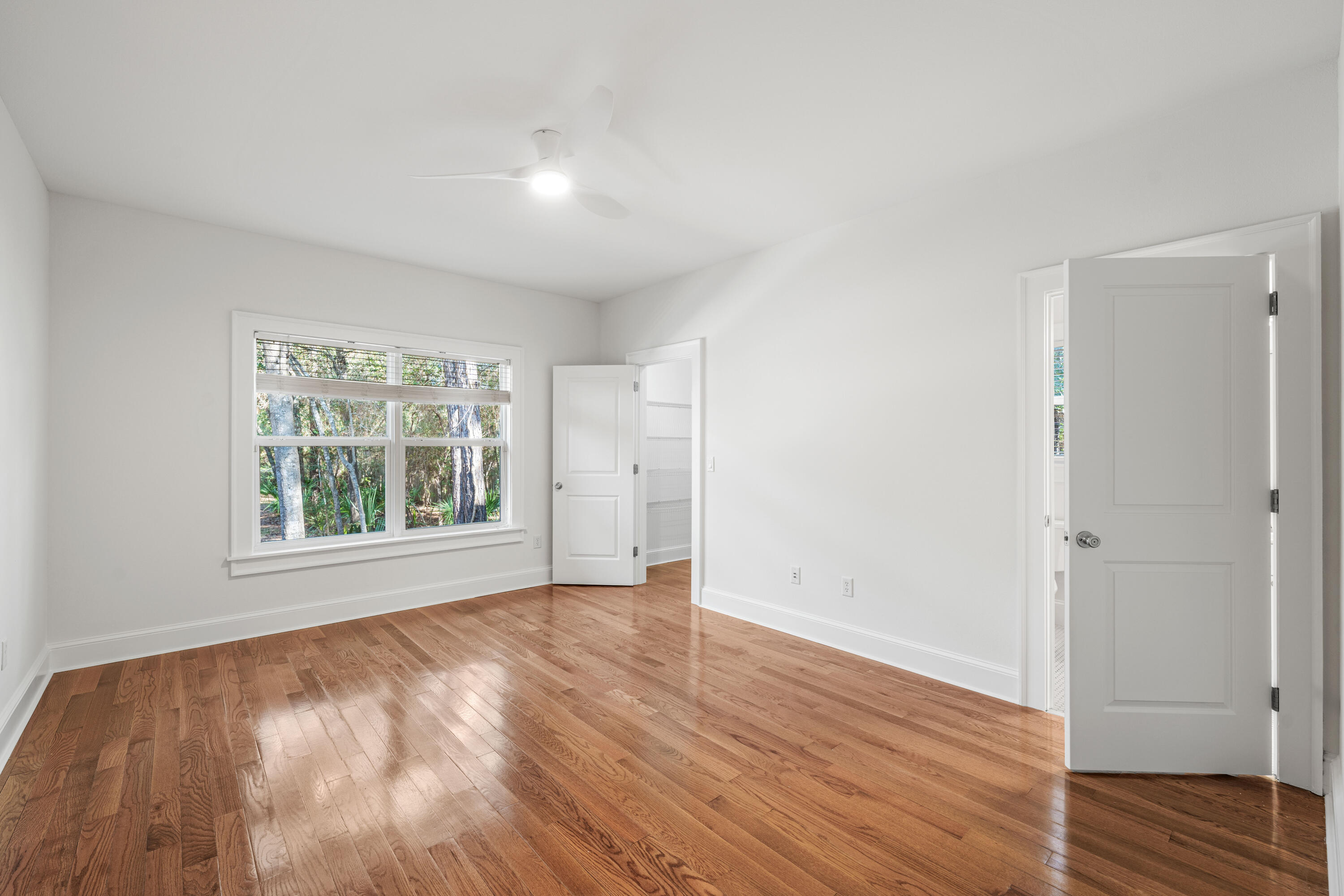 611 Amelia Lane Santa Rosa Beach, FL 32459 - Photo 27 of 59 an empty room with wooden floor and windows