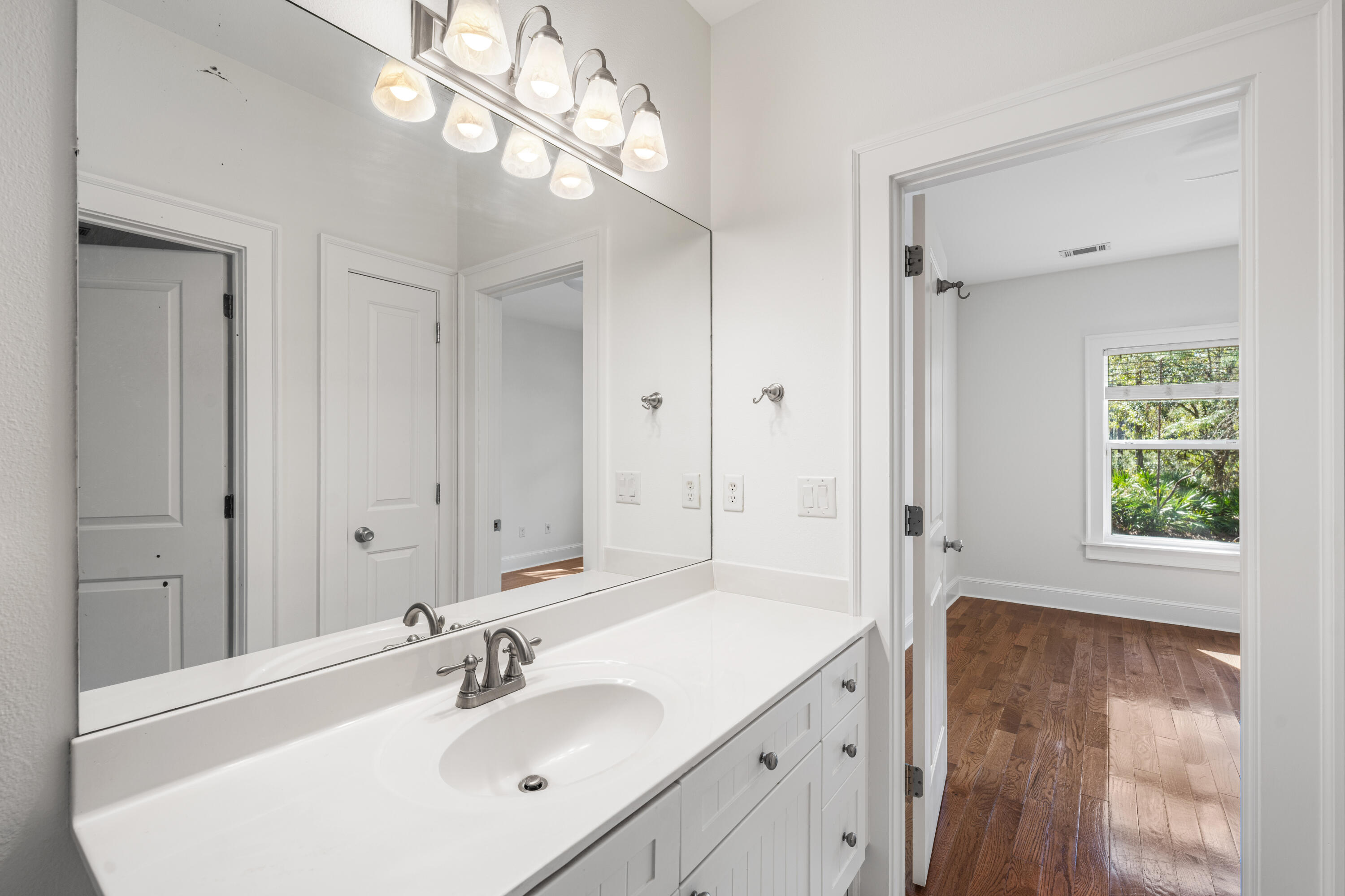 611 Amelia Lane Santa Rosa Beach, FL 32459 - Photo 29 of 59 a bathroom with a sink a large mirror and a bathtub