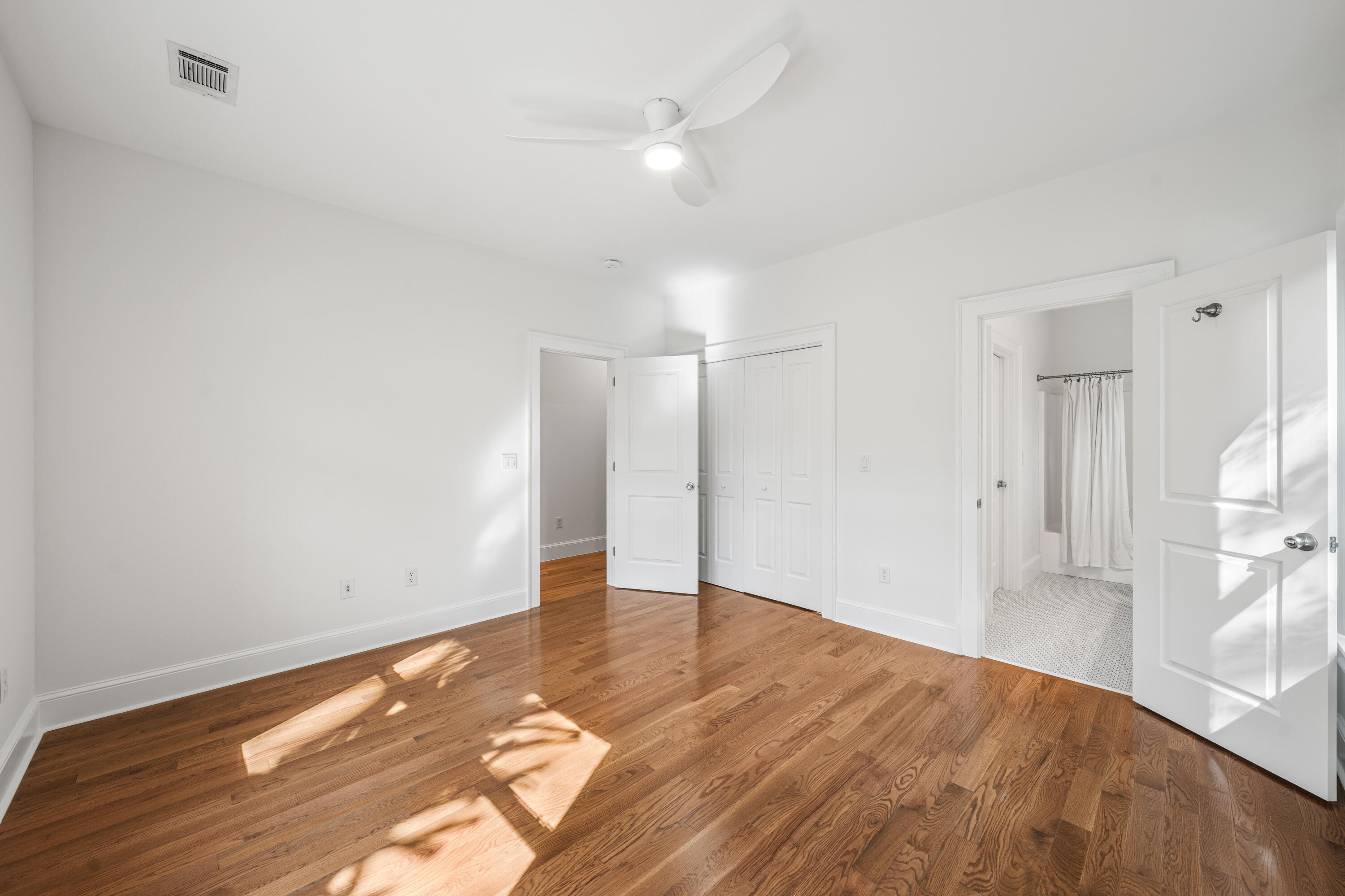 611 Amelia Lane Santa Rosa Beach, FL 32459 - Photo 32 of 59 a view of empty room with wooden floor and fan
