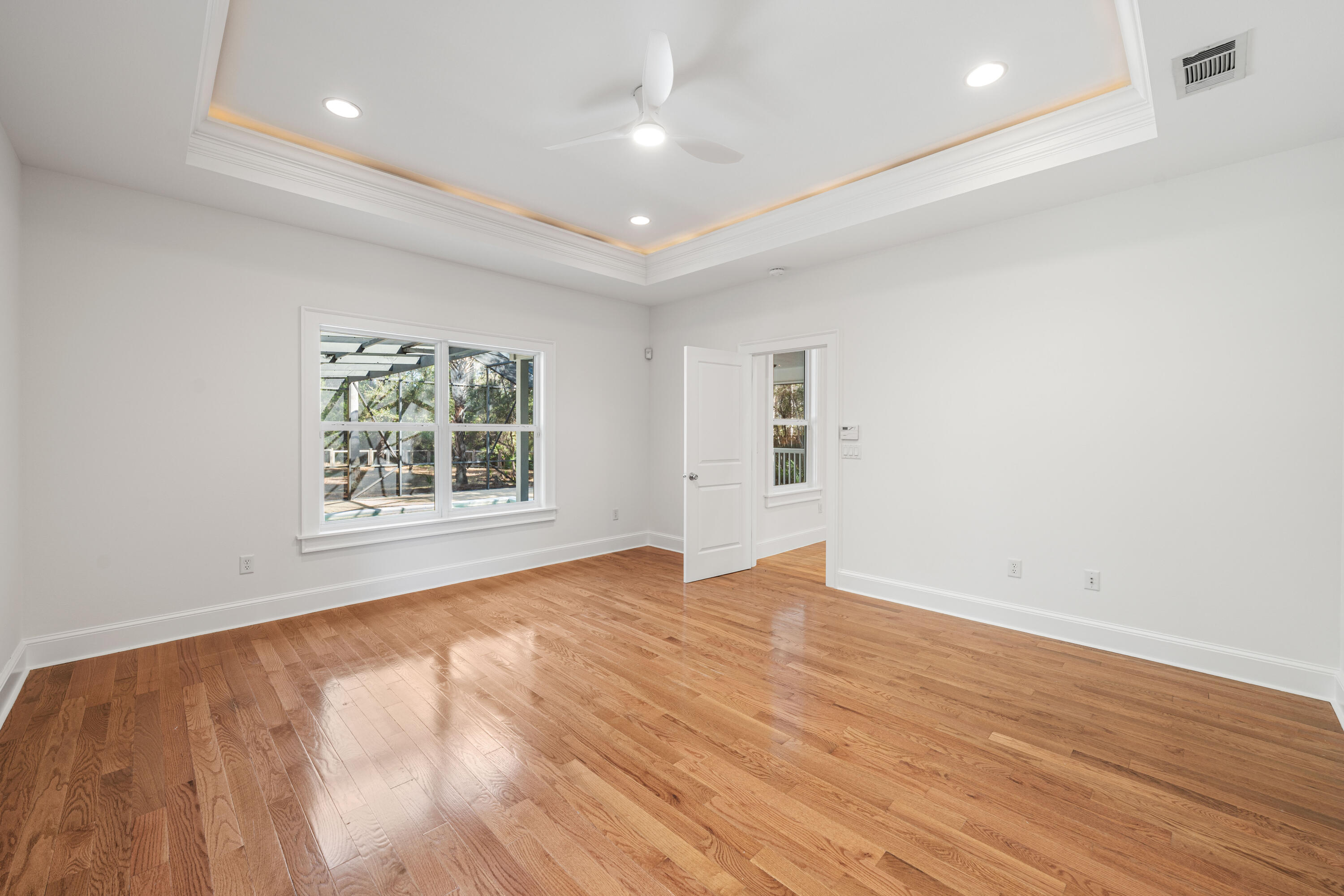 611 Amelia Lane Santa Rosa Beach, FL 32459 - Photo 35 of 59 an empty room with wooden floor and windows