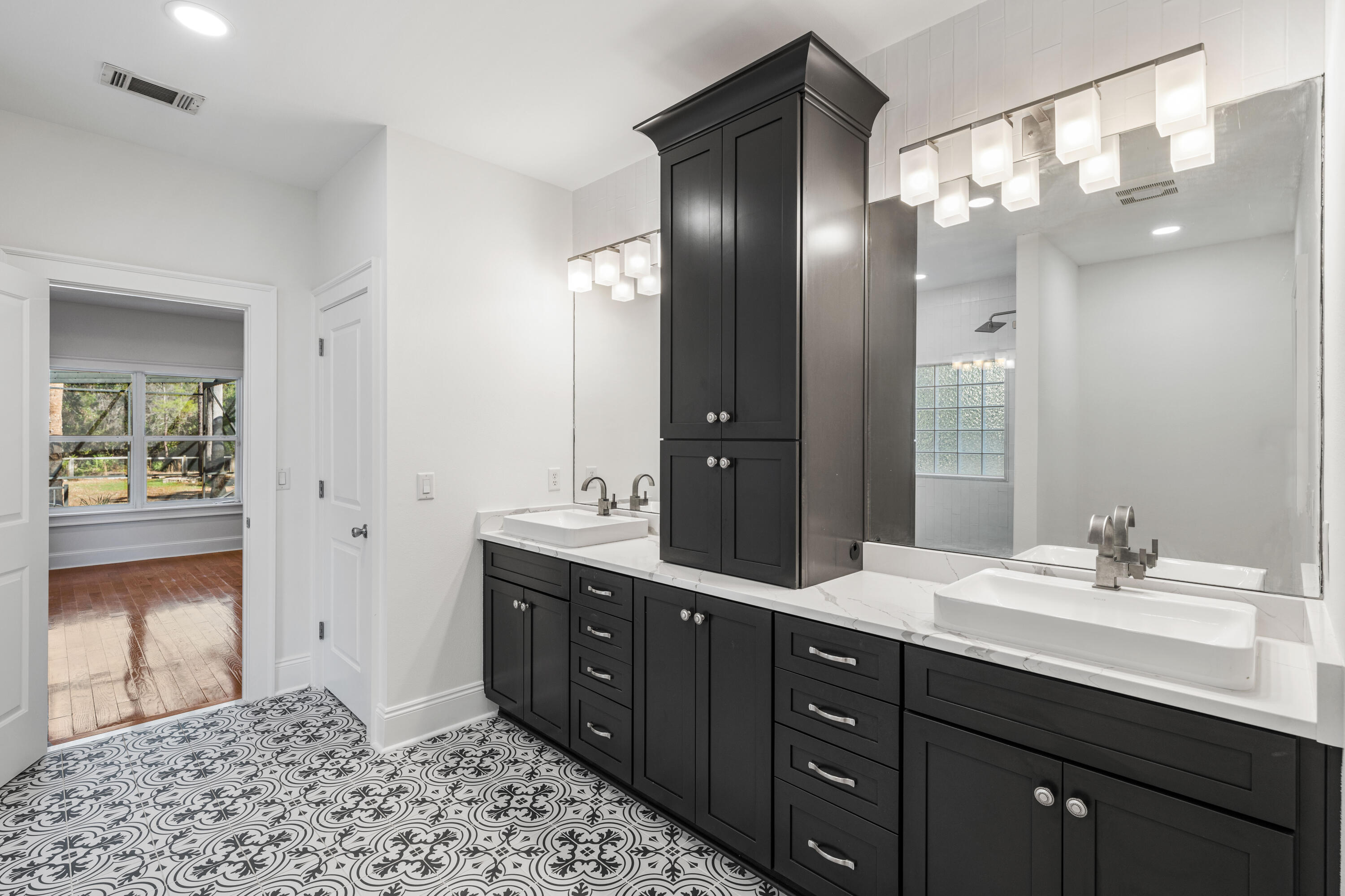 611 Amelia Lane Santa Rosa Beach, FL 32459 - Photo 38 of 59 a spacious bathroom with a double vanity sink and a mirror