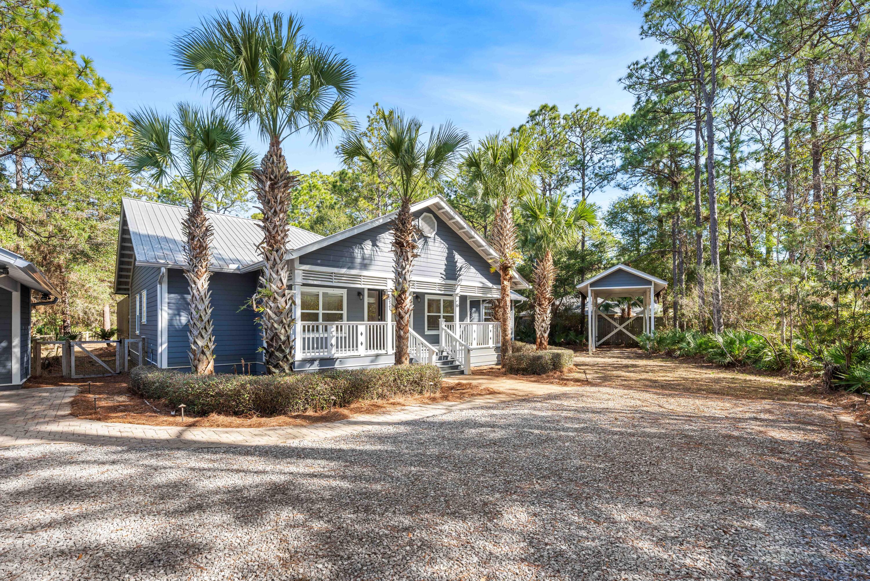 611 Amelia Lane Santa Rosa Beach, FL 32459 - Photo 4 of 59 a front view of a house with a garden