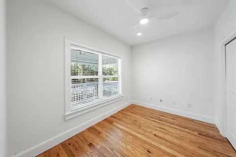 a bed sitting in a balcony next to a yard