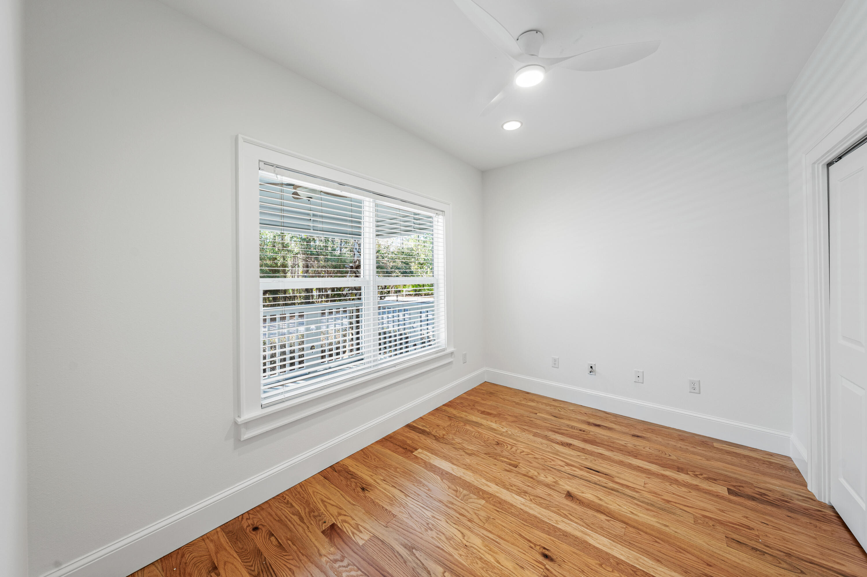 611 Amelia Lane Santa Rosa Beach, FL 32459 - Photo 43 of 59 a view of an empty room with wooden floor and a window