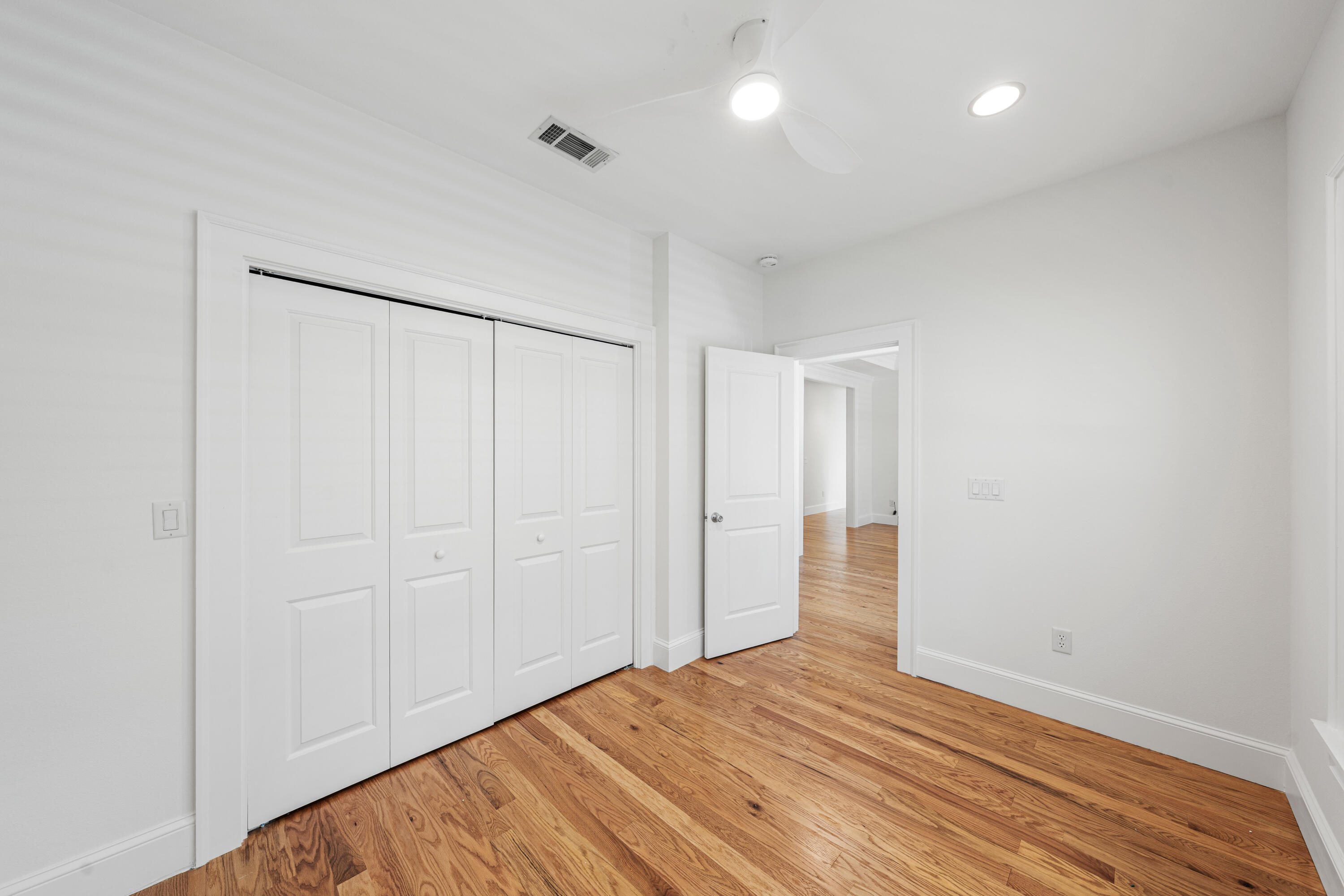 611 Amelia Lane Santa Rosa Beach, FL 32459 - Photo 44 of 59 a view of an empty room with wooden floor