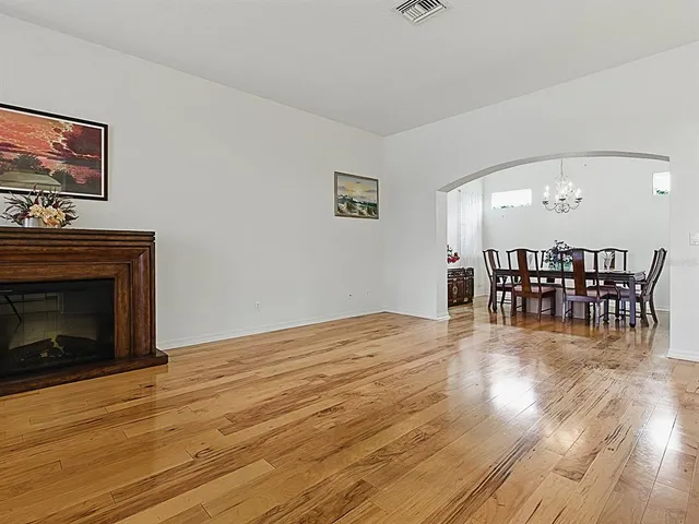 a view of a dining room with furniture wooden floor and chandelier